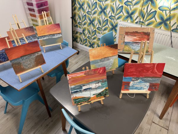 Eight Turner inspired paintings on their easels at the art room at the Eat Kent Mind office in Ramsgate