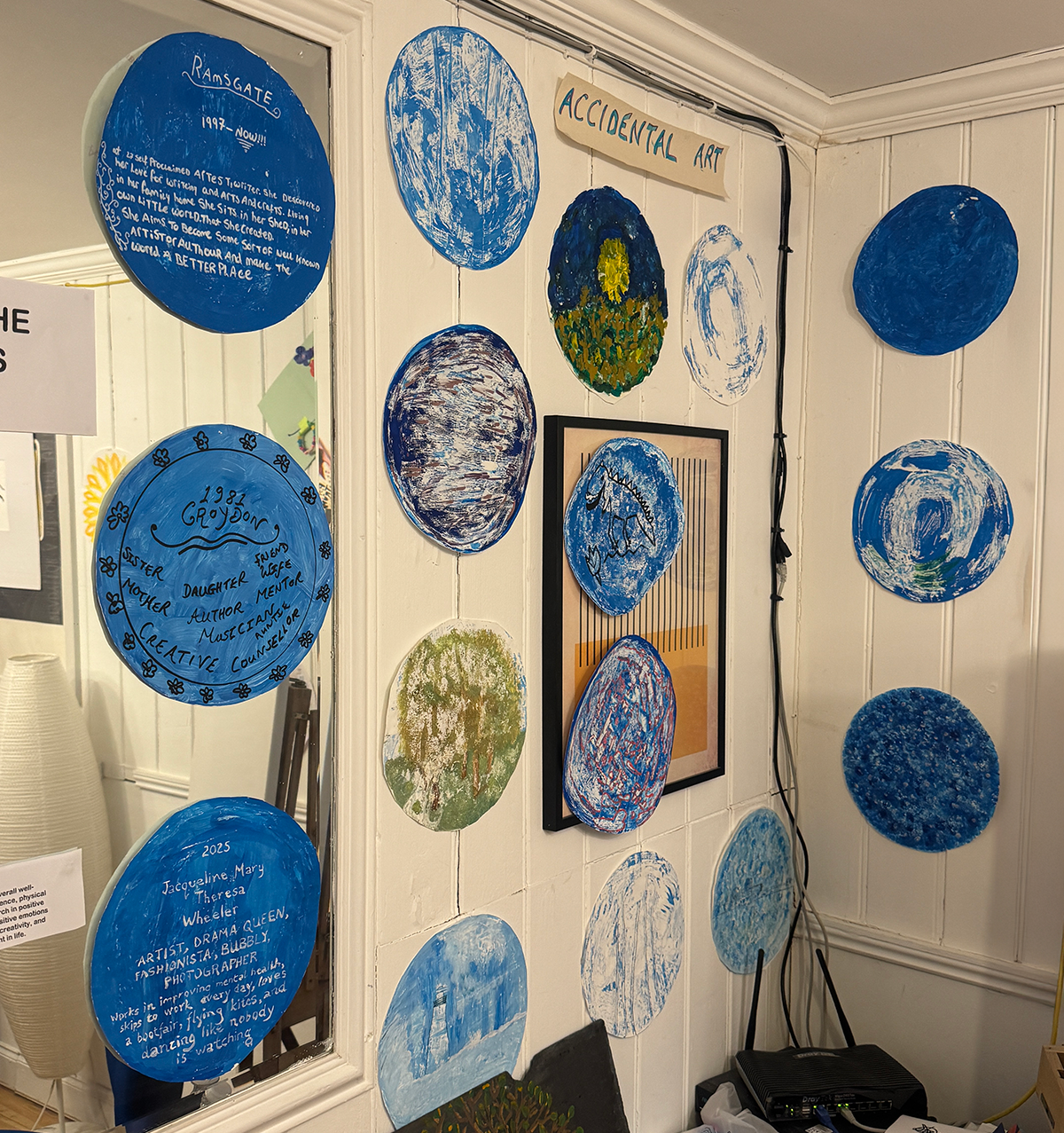 For Front cover A selection of some of the artwork for the Exhibition produced in circles with a blue theme