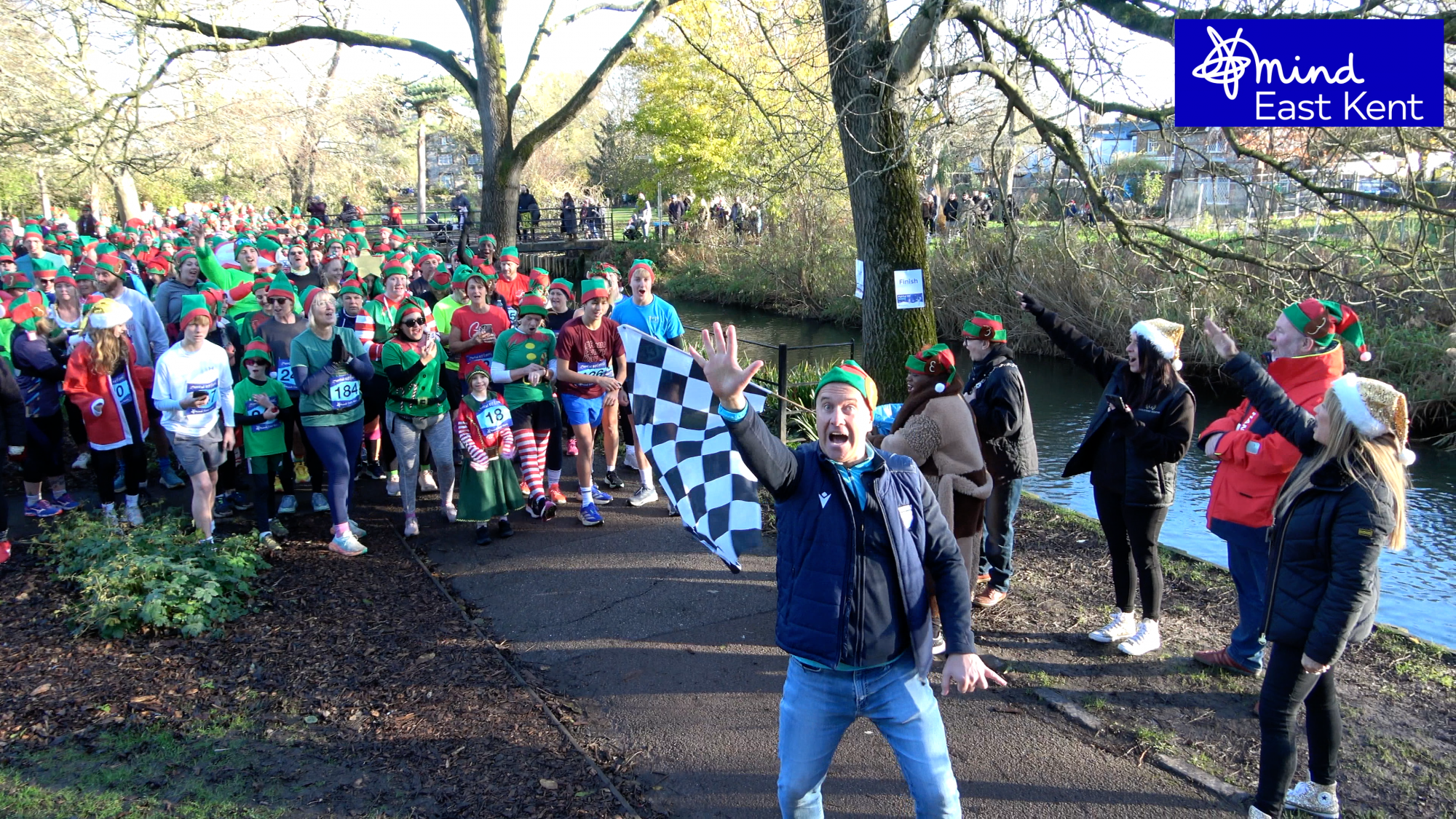 The start of Mental Elf Canterbury 2025 with CBeebies Mister Maker waving the starting flag