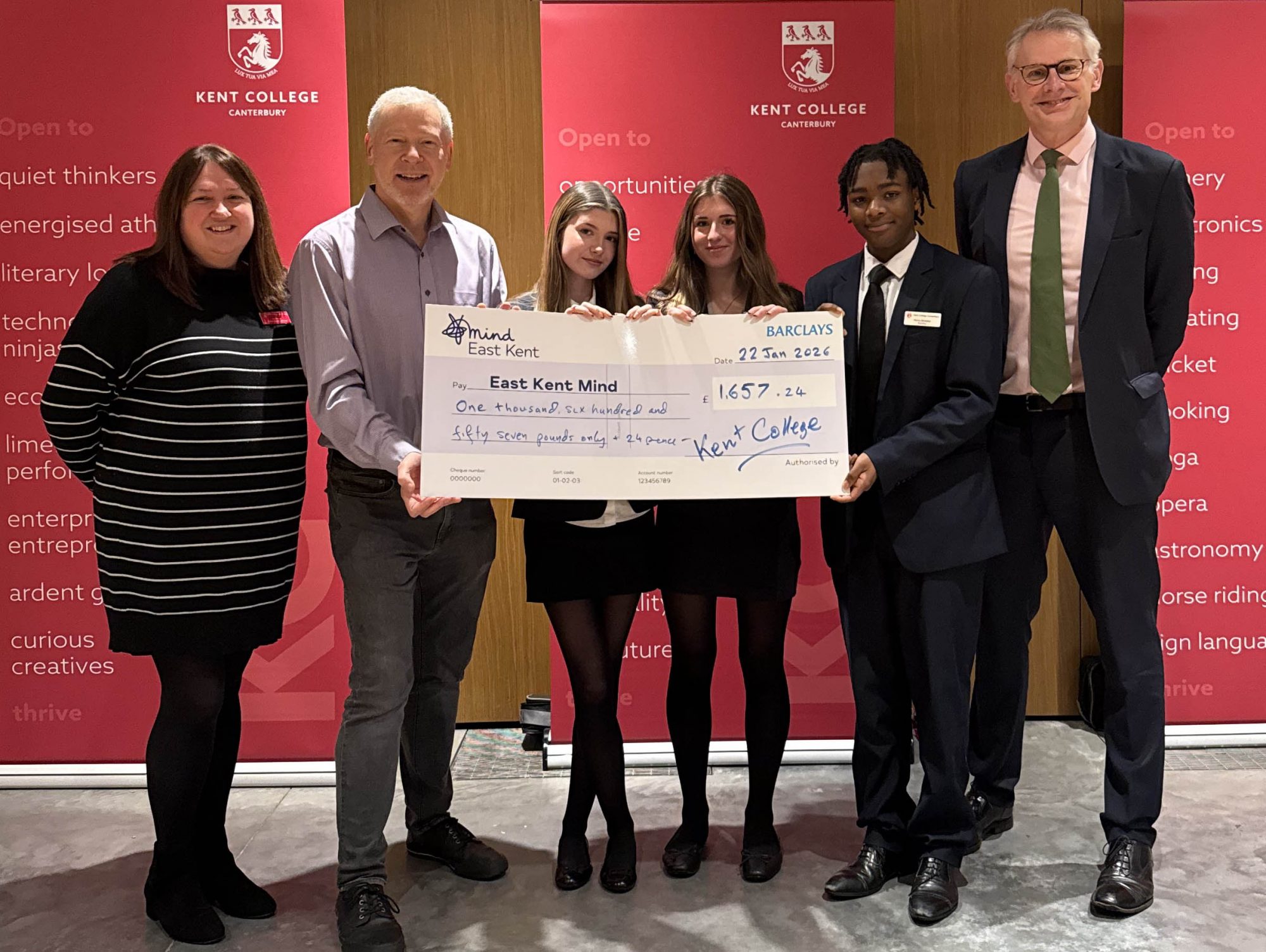 IMG_1903 4 3 crop new Students and staff from Kent College are stood holding a large cheque with Simon Dolby, East Kent Mind Development Lead