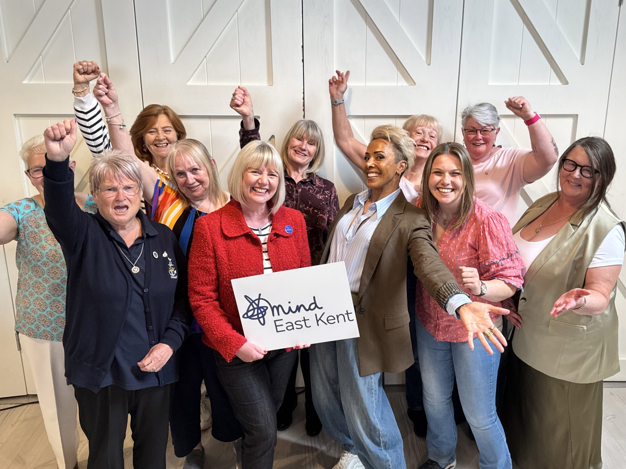Dame Kelly Holmes stood in the middle with nine members of the Thanet Female Veterans Group all cheering, with the lead Karen Brinkman holding an East Kent Mind logo