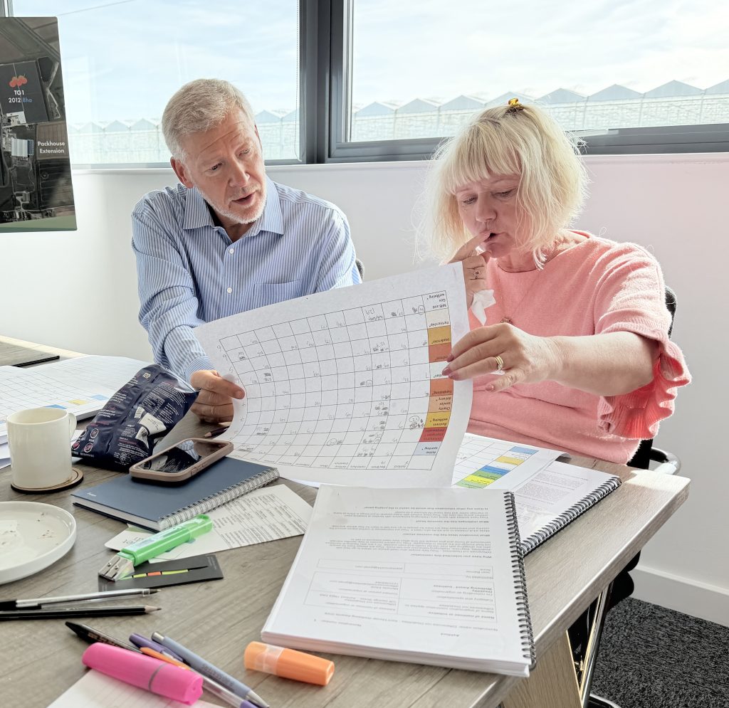Two people looking at score sheet